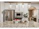 Modern kitchen with stainless steel appliances, granite countertops, and an island with bar seating for a stylish cooking area at 12505 Branford St, Carmel, IN 46032
