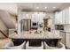 Spacious kitchen island with granite countertops, seating, stainless steel appliances, and white cabinetry, creating a modern kitchen space at 12505 Branford St, Carmel, IN 46032