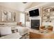 Bright living room with a vaulted ceiling, fireplace, built-in shelving, and comfortable seating at 12505 Branford St, Carmel, IN 46032