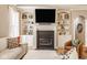 Comfortable living room features a fireplace, custom built-ins, and a wall-mounted television at 12505 Branford St, Carmel, IN 46032