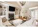 Vaulted living room with fireplace, TV, large sofa, and natural light from the backyard at 12505 Branford St, Carmel, IN 46032