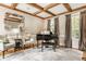Inviting living room with coffered ceilings, grand piano, and natural light from large windows at 12505 Branford St, Carmel, IN 46032
