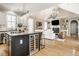 Open-concept living space featuring a kitchen island, vaulted ceilings, fireplace and hardwood floors providing a modern feel at 12505 Branford St, Carmel, IN 46032
