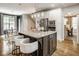 Open-concept kitchen with a central island, stainless steel appliances, bar seating, and adjacent dining area perfect for entertaining at 12505 Branford St, Carmel, IN 46032