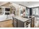 Spacious open-concept living space with a large kitchen island, modern appliances, and an adjacent living area with a fireplace at 12505 Branford St, Carmel, IN 46032