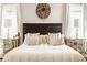 Cozy main bedroom boasts a king bed, decorative wall art and mirrored nightstands at 12505 Branford St, Carmel, IN 46032
