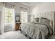 Inviting bedroom featuring a plush bed, accent wall, and large windows at 12505 Branford St, Carmel, IN 46032