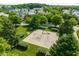 Aerial view of a neighborhood playground with swings, slide, and pea gravel safety surface at 12505 Branford St, Carmel, IN 46032