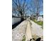 View of the backyard, featuring a gravel driveway and a storage shed at 1358 Hiatt St, Indianapolis, IN 46221