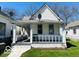 Charming house featuring a covered front porch and a well-maintained lawn at 1358 Hiatt St, Indianapolis, IN 46221