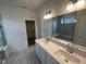 Bathroom with double sink vanity, quartz countertop, and glass-enclosed shower at 13646 Grand Abbey Way, Fishers, IN 46037