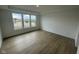 Spacious bedroom with large windows providing lots of natural light and plank flooring at 13646 Grand Abbey Way, Fishers, IN 46037