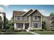 Charming two-story home with detailed architectural design and welcoming front porch at 13646 Grand Abbey Way, Fishers, IN 46037