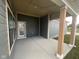 An inviting covered front porch with wooden support pillars and convenient access to the front door at 13646 Grand Abbey Way, Fishers, IN 46037