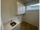 Laundry room with quartz countertop, stainless steel sink, and modern cabinetry at 13646 Grand Abbey Way, Fishers, IN 46037