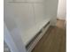 Organized mud room featuring built-in bench with storage cubbies and hardwood flooring at 13646 Grand Abbey Way, Fishers, IN 46037