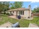Brick home featuring a patio, green lawn, and firepit sitting area in backyard at 1415 Section St, Plainfield, IN 46168