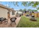 Inviting backyard with a stone patio, green lawn, firepit, and seating area at 1415 Section St, Plainfield, IN 46168