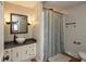 Bright bathroom with a vessel sink, stylish mirror, and shower with decorative curtain at 1415 Section St, Plainfield, IN 46168
