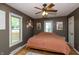 Bedroom with wood floors, ceiling fan and two windows letting in natural light at 1415 Section St, Plainfield, IN 46168