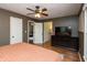 Bedroom with wood flooring, ceiling fan, and an opening to an adjoining room at 1415 Section St, Plainfield, IN 46168