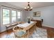 Bright dining room with a wooden table, modern chandelier, and large windows at 1415 Section St, Plainfield, IN 46168