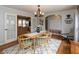 Open dining room with light-colored walls and wooden table, open to the foyer and kitchen at 1415 Section St, Plainfield, IN 46168