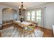 Open dining room with modern chandelier, and large windows offering an abundance of natural light at 1415 Section St, Plainfield, IN 46168