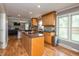 Spacious kitchen area with wood cabinets, stainless steel appliances and breakfast bar overlooking other rooms at 1415 Section St, Plainfield, IN 46168