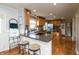 Bright kitchen featuring wood cabinets, stainless steel appliances, island and eat-in breakfast bar with seating at 1415 Section St, Plainfield, IN 46168