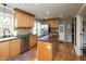 Well lit kitchen featuring wood cabinets, stainless steel appliances and island with breakfast bar at 1415 Section St, Plainfield, IN 46168