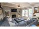 Cozy living room with a brick fireplace, large sectional sofa, and ample natural light at 1415 Section St, Plainfield, IN 46168