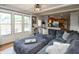 Spacious living room with a large sectional sofa, connecting to the kitchen and abundant natural light at 1415 Section St, Plainfield, IN 46168