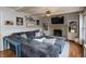 Comfortable living room with a large sectional sofa, brick fireplace, and decorative shelves at 1415 Section St, Plainfield, IN 46168