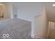 Spacious bonus room with plush carpeting, neutral walls, and access to a staircase at 14892 Higgins Dr, Westfield, IN 46074