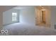 Spacious bonus room featuring plush carpeting, natural light, and access to a hallway for versatile living at 14892 Higgins Dr, Westfield, IN 46074