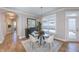 Elegant dining room featuring a round glass table, chandelier, and modern decor at 14892 Higgins Dr, Westfield, IN 46074