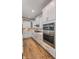 Modern kitchen with stainless steel appliances, white cabinets, and a gas cooktop at 14892 Higgins Dr, Westfield, IN 46074