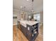 Kitchen island featuring a white countertop, storage, a sink, and pendant lighting at 14892 Higgins Dr, Westfield, IN 46074