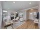 Open-concept living room with a fireplace, ample seating, and hardwood floors, perfect for entertaining at 14892 Higgins Dr, Westfield, IN 46074