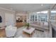 Bright and airy living room with a comfortable sofa, large windows, and a stylish ottoman at 14892 Higgins Dr, Westfield, IN 46074