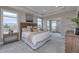 Luxurious main bedroom featuring a tray ceiling, large windows, and a comfortable sitting area at 14892 Higgins Dr, Westfield, IN 46074