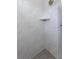 Contemporary shower featuring sleek white marble tile, a built-in shelf, and a modern showerhead at 14892 Higgins Dr, Westfield, IN 46074