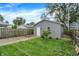 The backyard features a well-maintained lawn, privacy fence, and detached garage with a white door at 1531 English Ave, Indianapolis, IN 46201