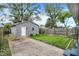 The backyard features a well-maintained lawn, privacy fence, and detached garage with a white door at 1531 English Ave, Indianapolis, IN 46201