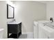 Well-lit bathroom featuring a vanity, sink and a modern washer and dryer at 1531 English Ave, Indianapolis, IN 46201