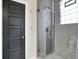 Modern bathroom featuring a tiled shower with glass door and neutral color palette at 1531 English Ave, Indianapolis, IN 46201