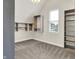 Bright bedroom featuring neutral colored carpet, a window, and closet space at 1531 English Ave, Indianapolis, IN 46201