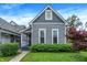 Charming gray two-story home featuring a well-maintained lawn and manicured landscaping at 1531 English Ave, Indianapolis, IN 46201