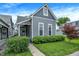 Charming gray two-story home featuring a well-maintained lawn and manicured landscaping at 1531 English Ave, Indianapolis, IN 46201